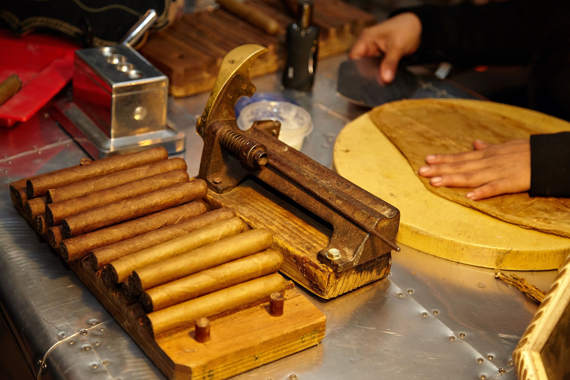 Cigar making with artisans in a traditional workshop, focusing on quality and craftsmanship
