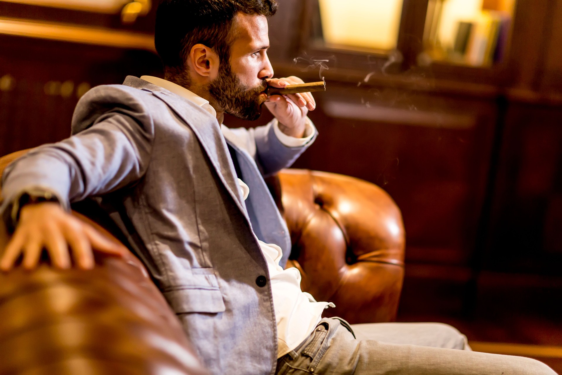 Handsome young man smoking cigar